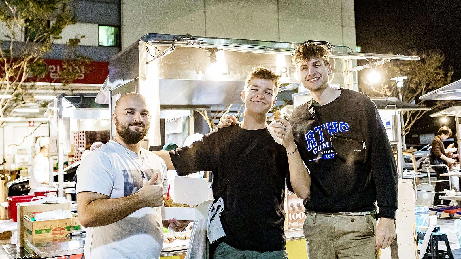 Foreigners enjoying snacks at Wolhwa Street Park Night Market